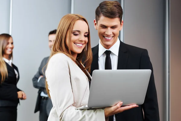 Two business people with laptop
