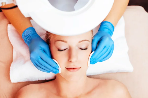 Woman getting a facial cleansing