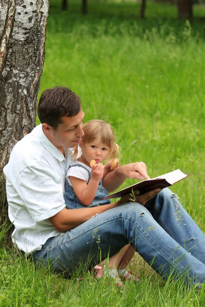 Father with baby daughter reading the Bible