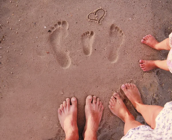 Family footprints in the sand