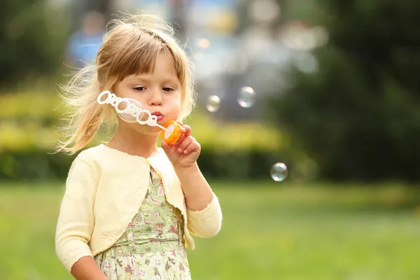 Little girl with soap bubbles