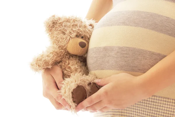Pregnant woman on a white background with bear