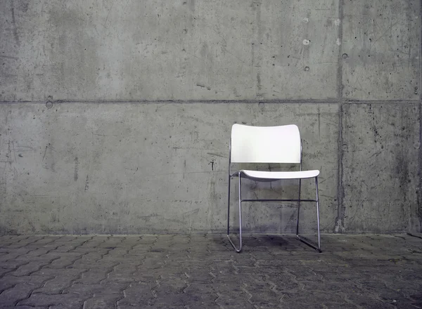 White chair and concrete wall