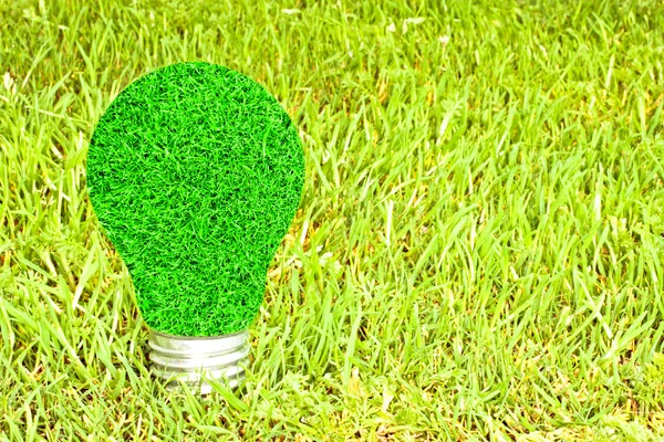 Light bulb made of green grass isolated on white background (eco