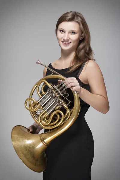 Woman musician with french horn