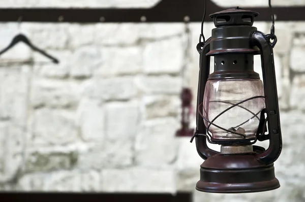 Kerosene lamp on the background of a stone wall