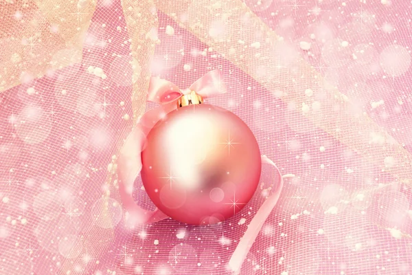 Soft pink christmas ball on a sparkling background
