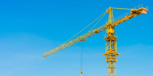 Hoisting crane and blue sky