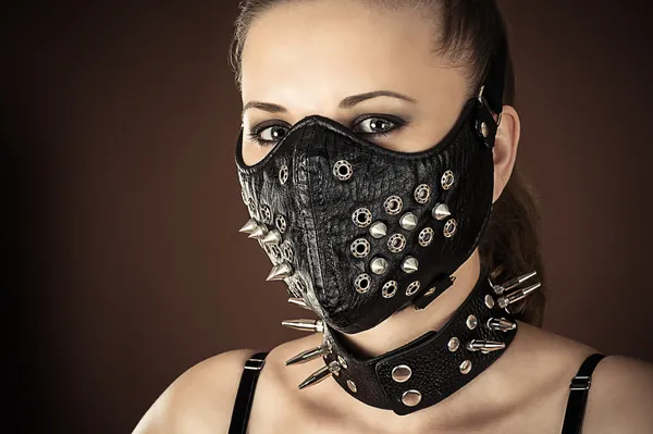 Woman in a mask with spikes
