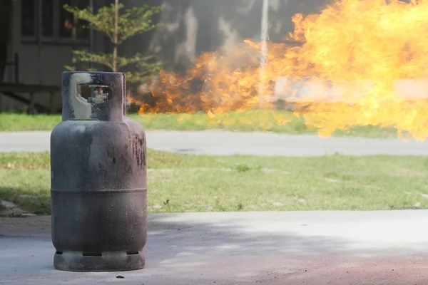 Fire burning over gas container