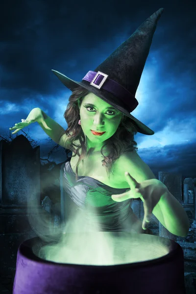 Witch with her cauldron on Halloween night