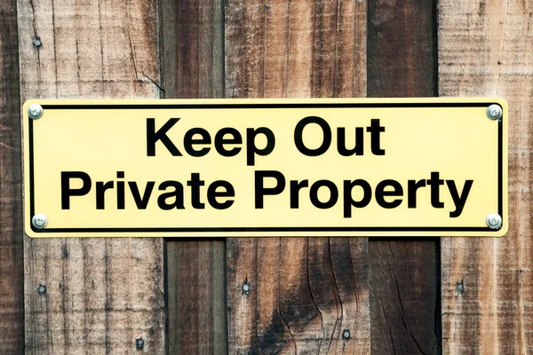 Pale Yellow and Black Sign Stating Keep Out Private Property