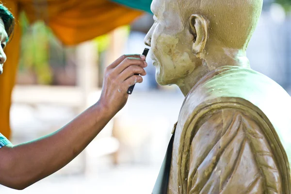 Sculpture Tool. artisan creates the head of a Buddhist monk