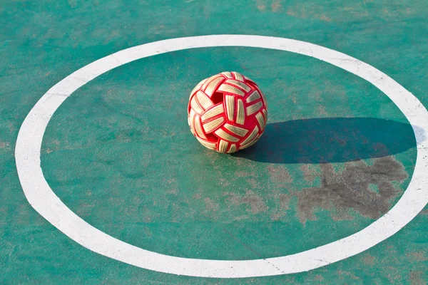 Plastic Sepak takraw ball on the cement floor.