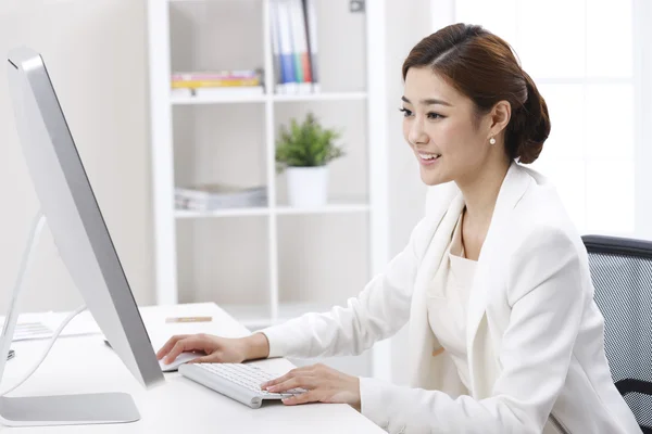 Businesswoman sitting in the office at the computer