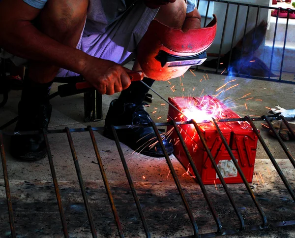 Worker welding connecting square bar