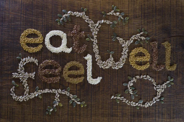 The Phrase Eat Well, Be Well Written And Decorated In Seeds