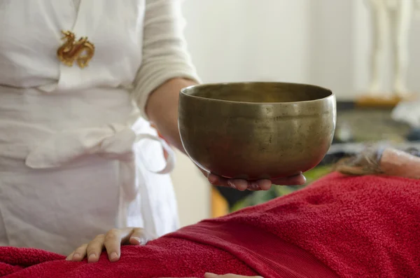 Practitioner healing with Tibetan singing bowls