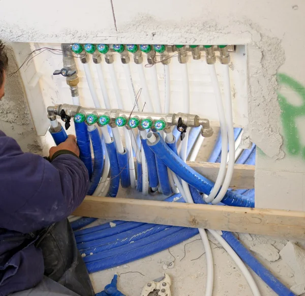 Construction site - Worker hands fixing heating system