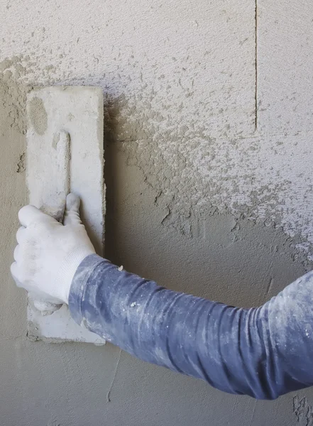 Worker performs internal plaster