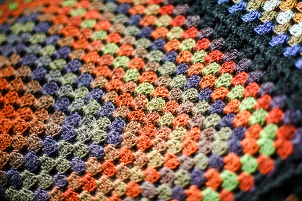 Handmade crochet multicolored afghan blanket of granny squares.