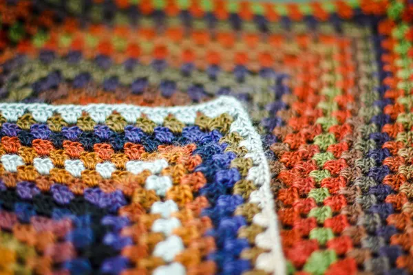 Handmade crochet multicolored afghan blanket of granny squares.
