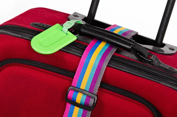 Closeup of luggage tag and colorful belt