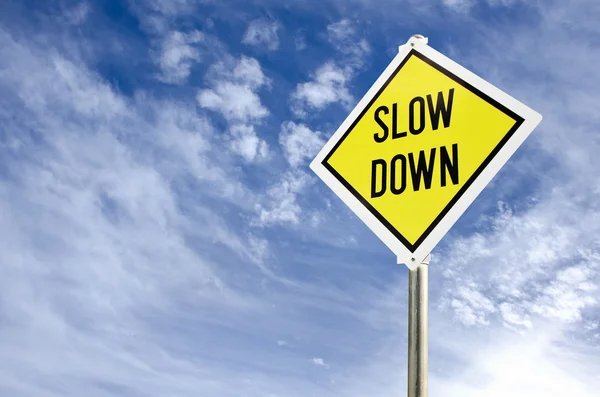 Slow Down yellow road sign