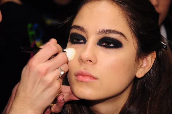 NEW YORK - FEBRUARY 16: A Model gets ready backstage at Stephen Burrows Fall Winter 2012 presentation at Audi Furum during New York Fashion Week on February 16, 2012 in New York