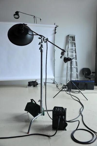 Empty photo studio with lighting equipment