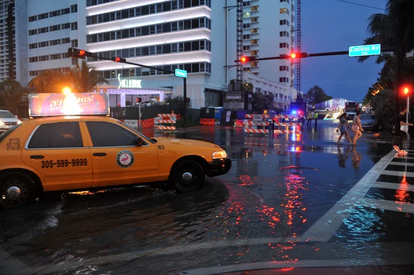Cars moving on flooded streets and roads of Miami South Beach