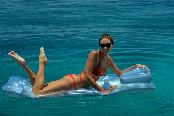 Woman in red bikini on floating device