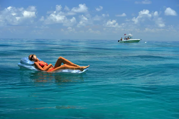 Woman in red bikini on floating device