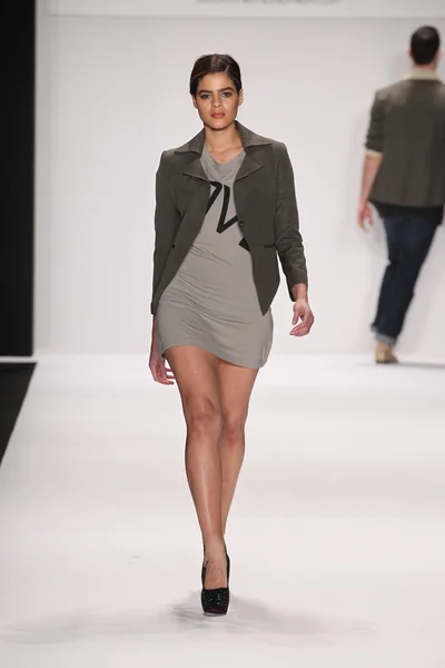Model walks runway wearing M The Movement