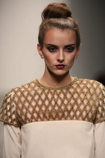 Model walks runway at Naveda Couture show