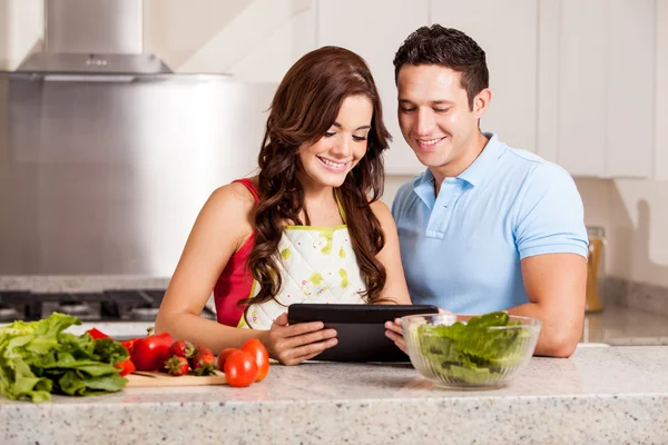 Couple looking for a dinner recipe in tablet computer