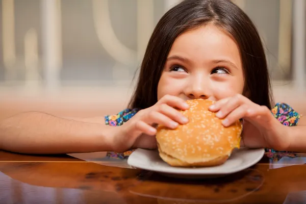 Little girl eating a sandwich