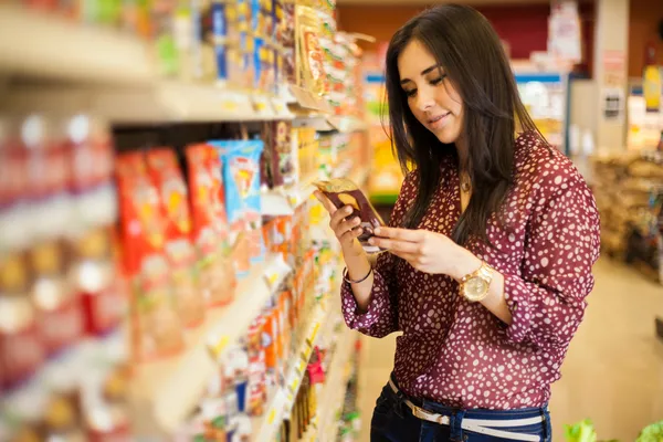 Young woman  looking and reading  the food label