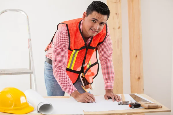Handsome young contractor working on a remodeling design for a houseg a house
