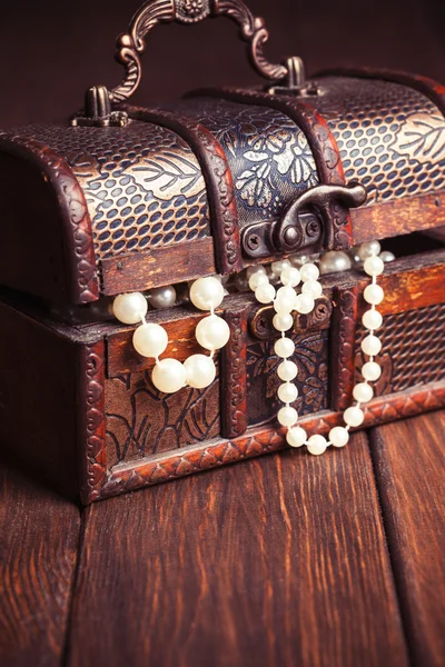 Old treasure chest with pearl necklaces