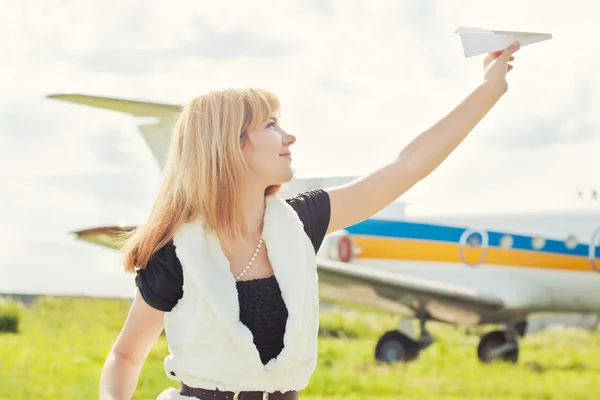Woman holding paper plane
