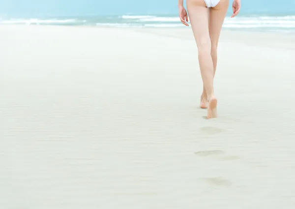 Slim girl walking to ocean