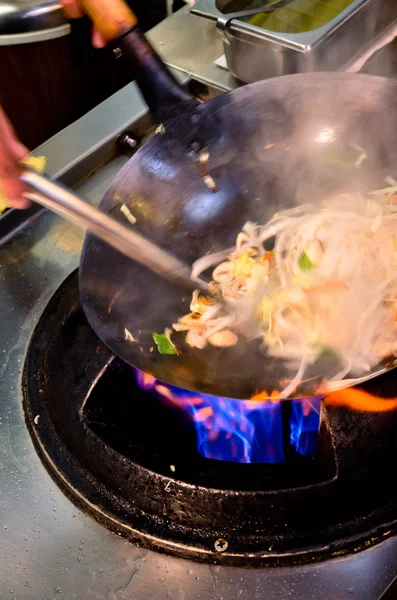 Preparing food in wok pan