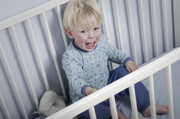 Crying boy in bed — Stock Photo #26687073