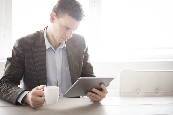 Businessman reading on tablet pc
