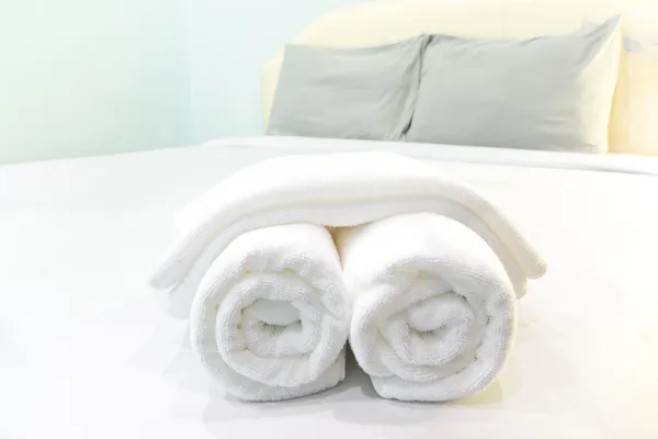 Bath towels rolled on bed