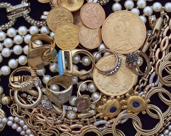 Jewels and golden coins closeup