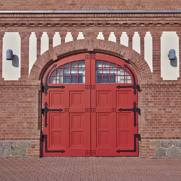 Entrance with arched red door and windows