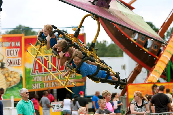 Teens Have Fun On Exciting Carnival Ride