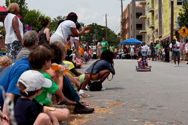 Spectators Cheer As Child Races in Soap Box Derby
